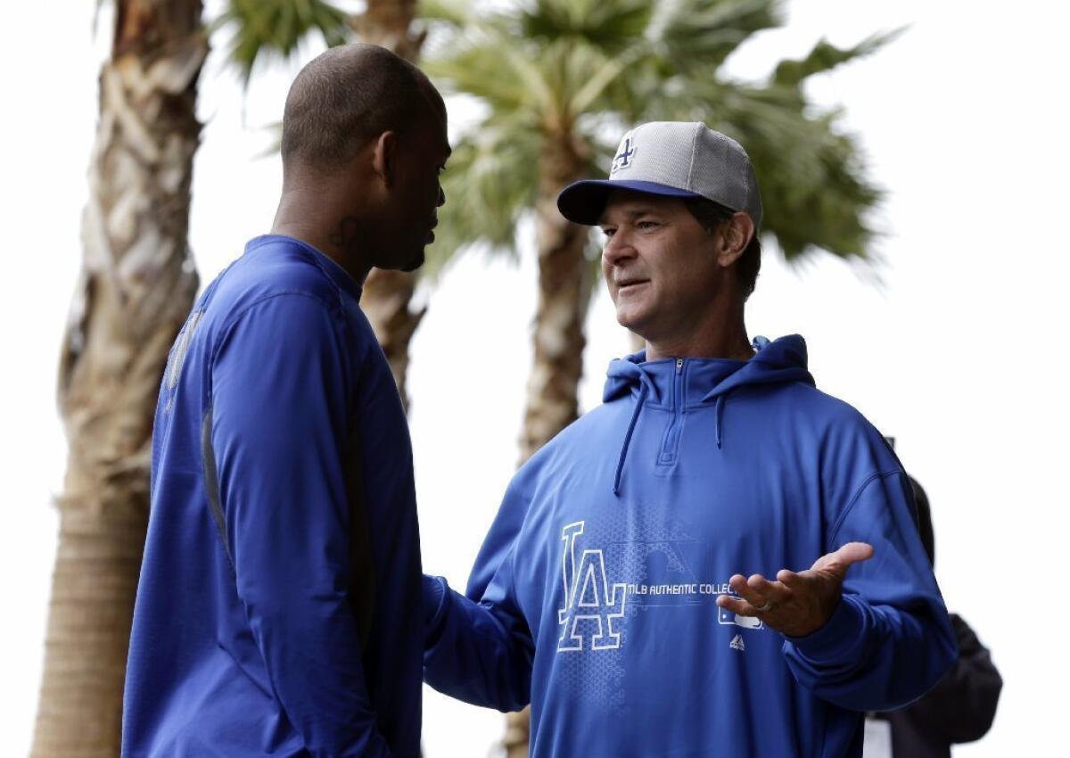 Carl Crawford talks with Dodgers Manager Don Mattingly last month.