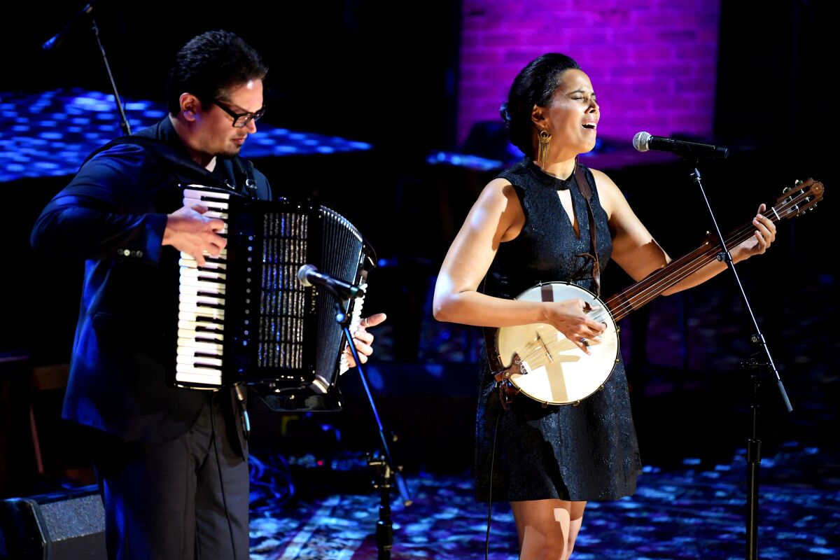 Francesco Turrisi, playing the accordion, and Rhiannon Giddens, singing and playing the banjo.