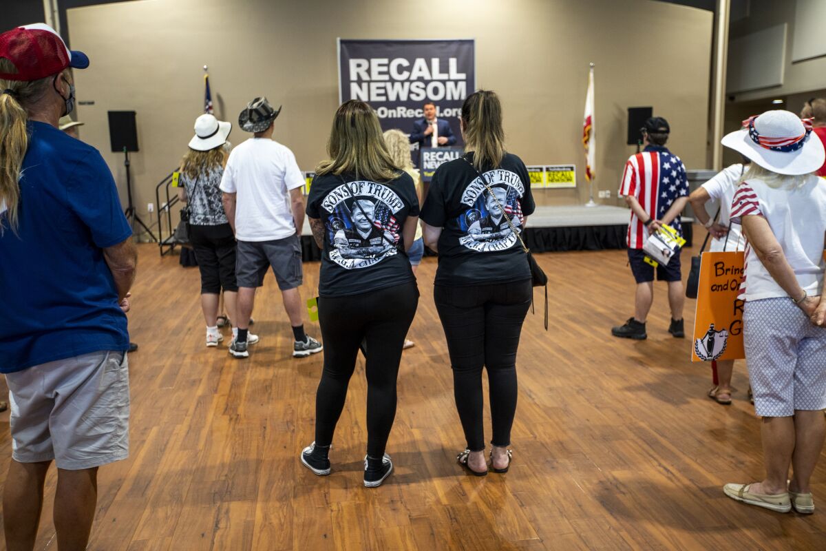 A group listens to "Yes on Recall" campaign Chairman Carl DeMaio during a rally at the Santa Clarita Activities Center.