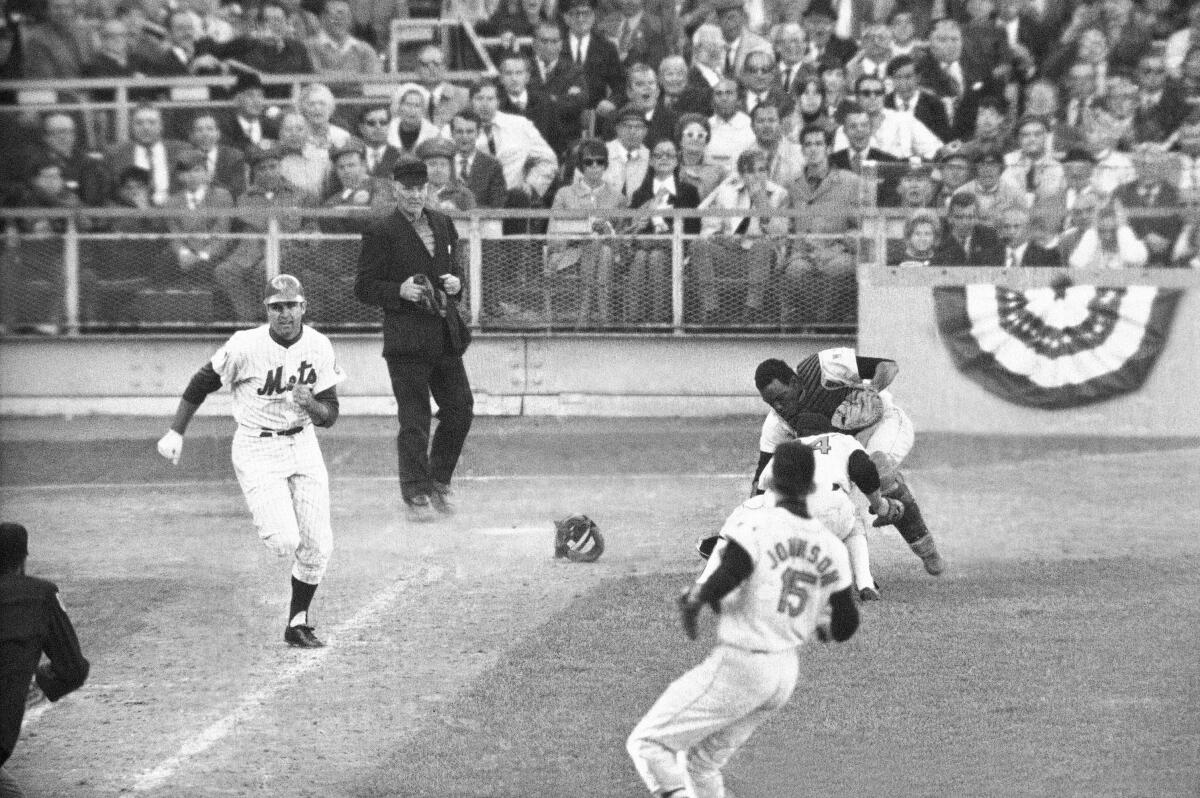 Orioles catcher Ellie Hendricks and pitcher Pete Richert reach for bunt laid down by J.C. Martin during a 1969 game