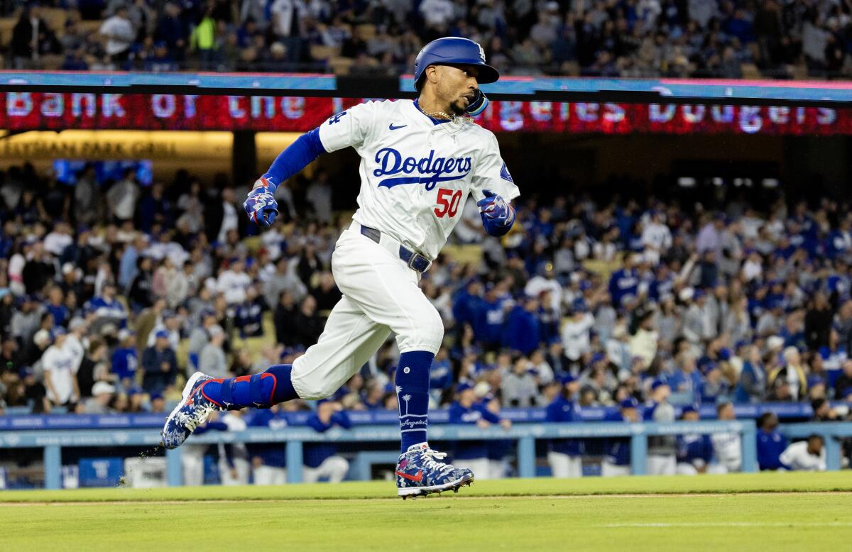 Dodgers shortstop Mookie Betts races around the bases on his way to a triple.