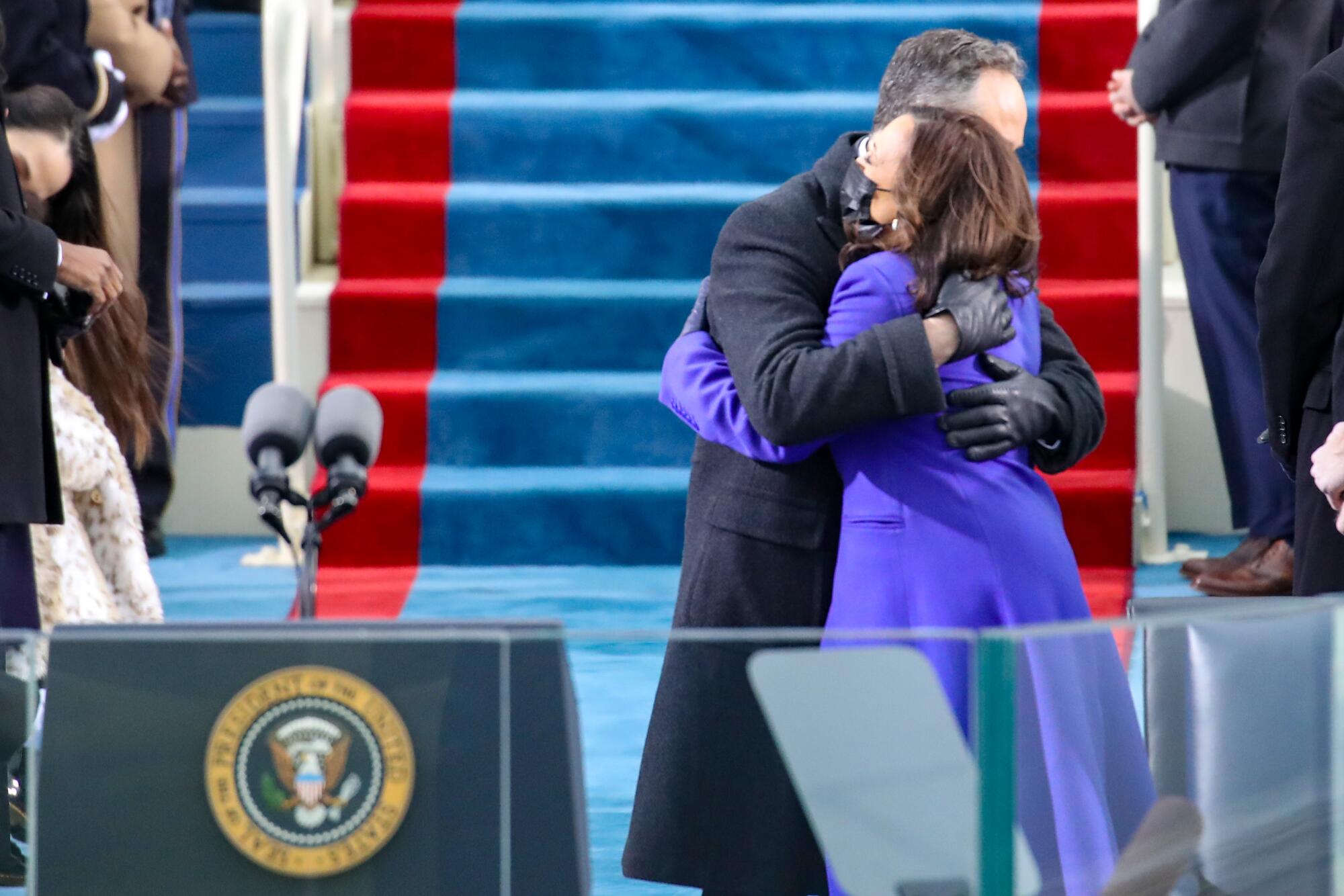 Vice President Kamala Harris hugs her husband, Doug Emhoff.