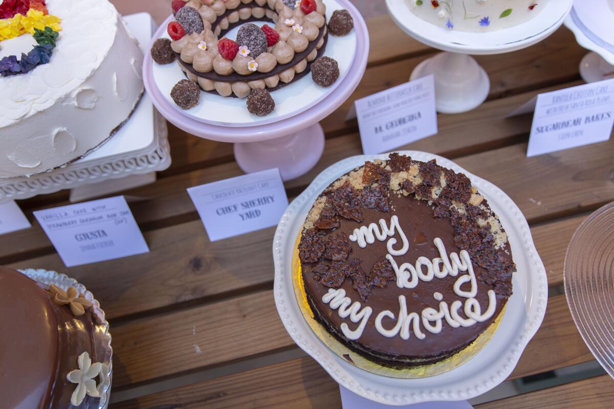 A cake iced with the words "my body my choice" and other desserts made for the Gather for Good bake sale