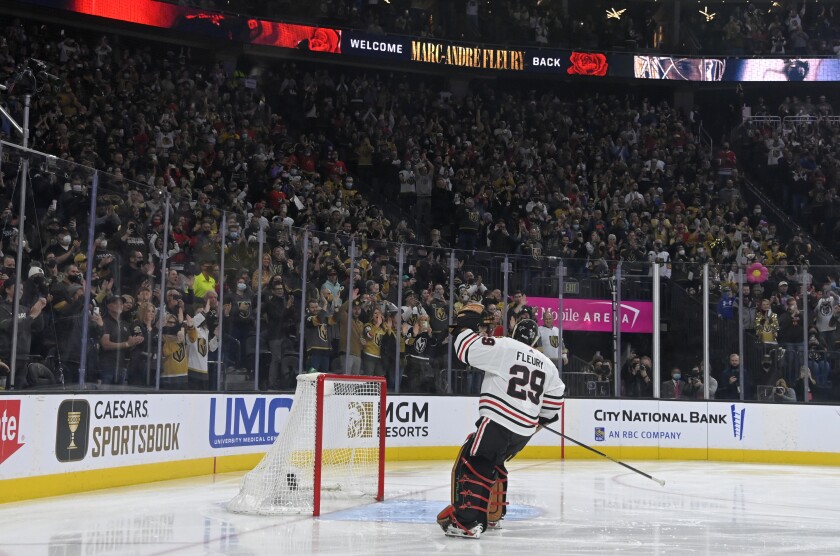 Chicago Blackhawks goaltender Marc-Andre Fleury acknowledges the crowd during a presentation before the team's NHL hockey game against the Vegas Golden Knights on Saturday, Jan. 8, 2022, in Las Vegas. (AP Photo/David Becker)