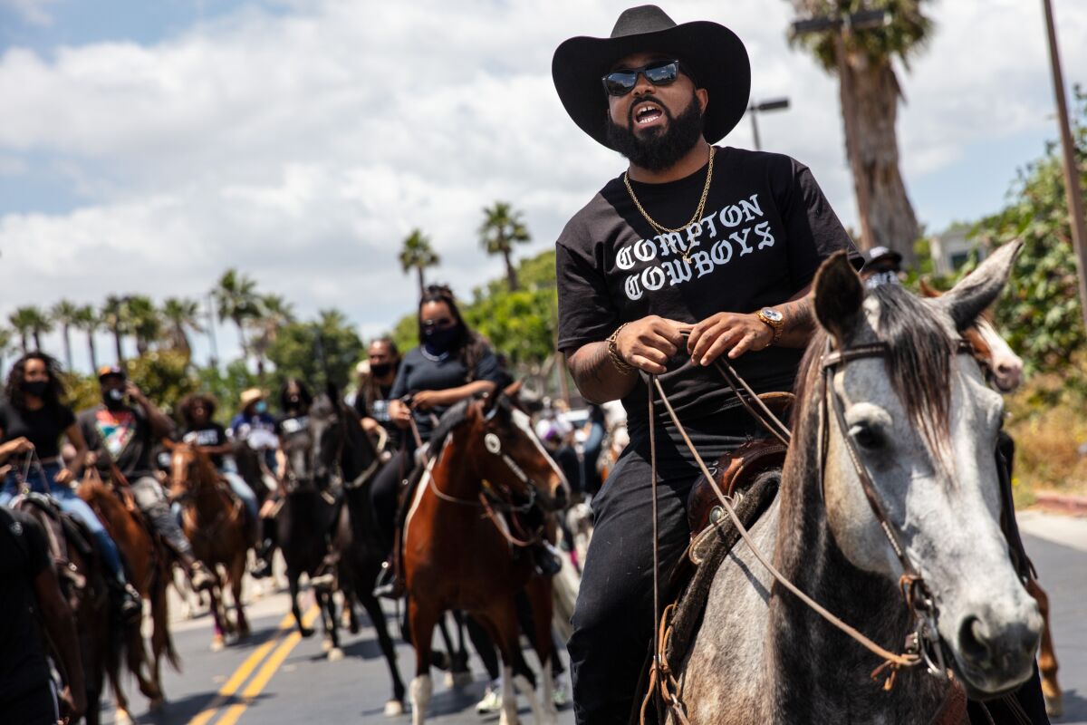 The Compton Cowboys on horseback, with Randy Savvy riding lead