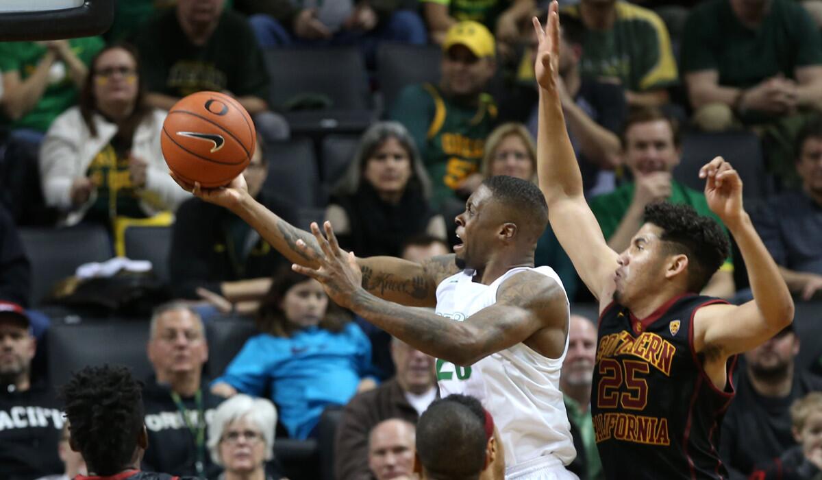 Oregon's Elgin Cook, top center, goes up for two points under pressure from USC's Bennie Boatwright, right, during the second half on Thursday.