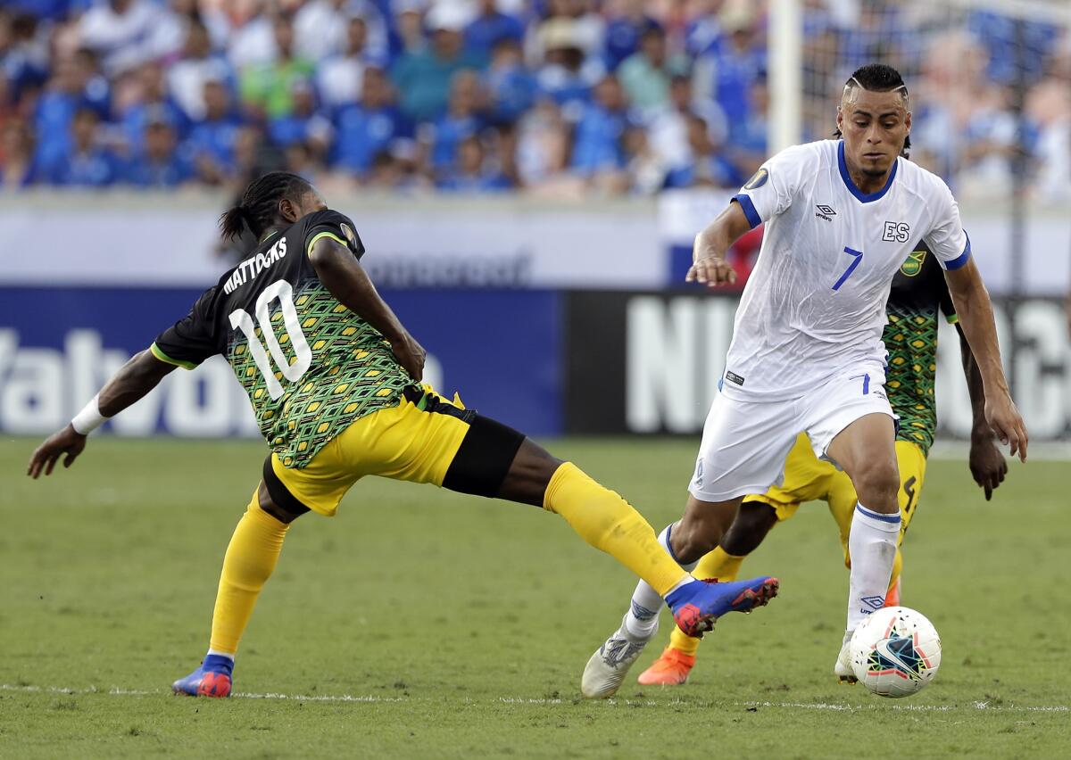 Jamaica forward Darren Mattocks (10) misses a kick as El Salvador midfielder Darwin Ceren (7) moves the ball past him during the second half of a CONCACAF Gold Cup soccer match Friday, June 21, 2019, in Houston.