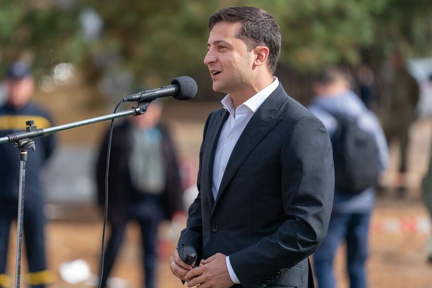 Ukrainian President Volodymyr Zelenskiy speaks to soldiers during his visit to military base outside Kyiv, Ukraine, Monday, Sept. 30, 2019. Ukraine's president says to media his country won't be pressured into opening an investigation into Democratic presidential candidate Joe Biden and his son. (Ukrainian Presidential Press Office via AP)