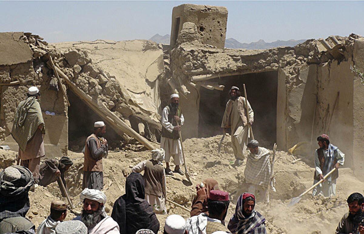 Afghan villagers gather at a house destroyed in an apparent NATO raid in Logar province, south of Kabul.