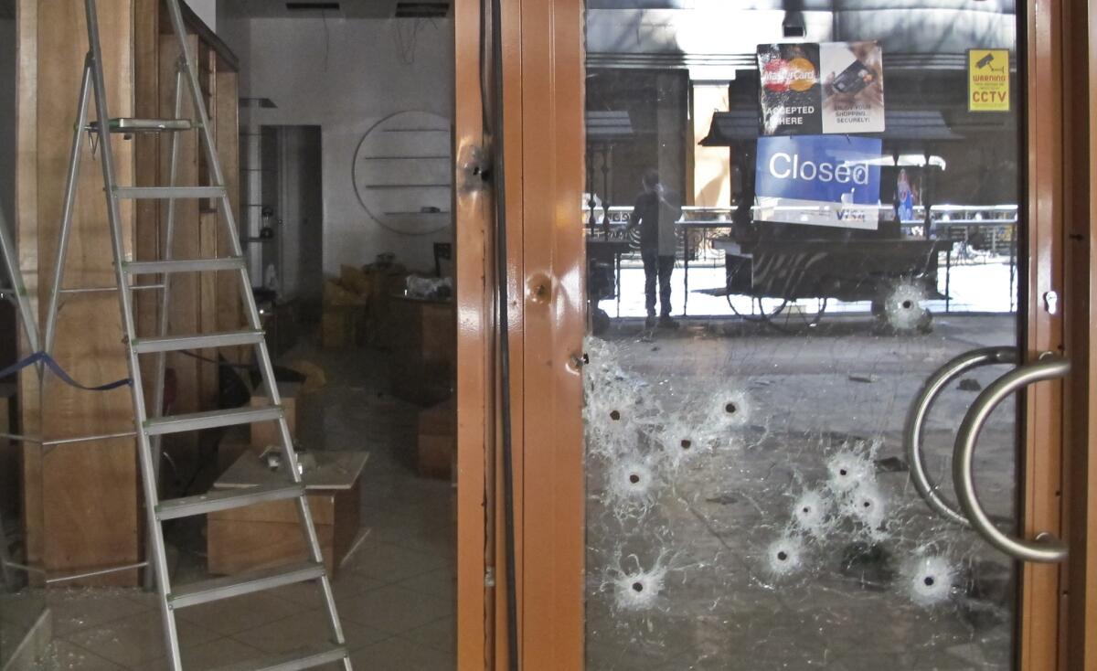 Bullet holes pepper the glass door of a shop in the Westgate Mall in Nairobi on Tuesday.