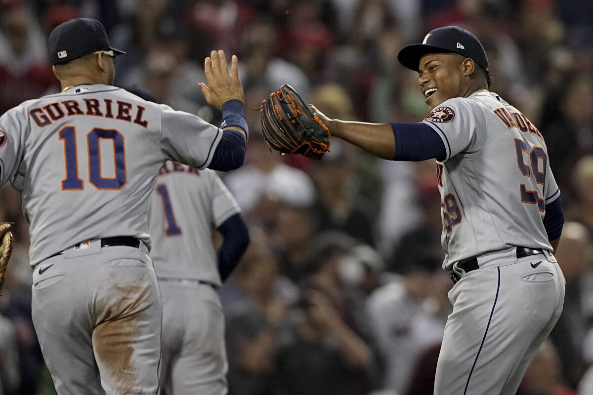 Houston Astros pitcher Framber Valdez celebrates the end of the seventh inning with first baseman Yuli Gurriel.