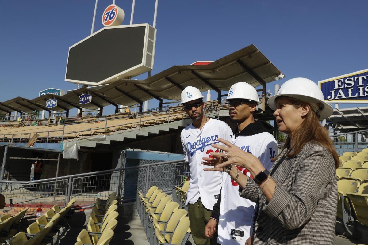 Dodgers players David Price and Mookie Betts tour new construction with Janet Marie Smith.