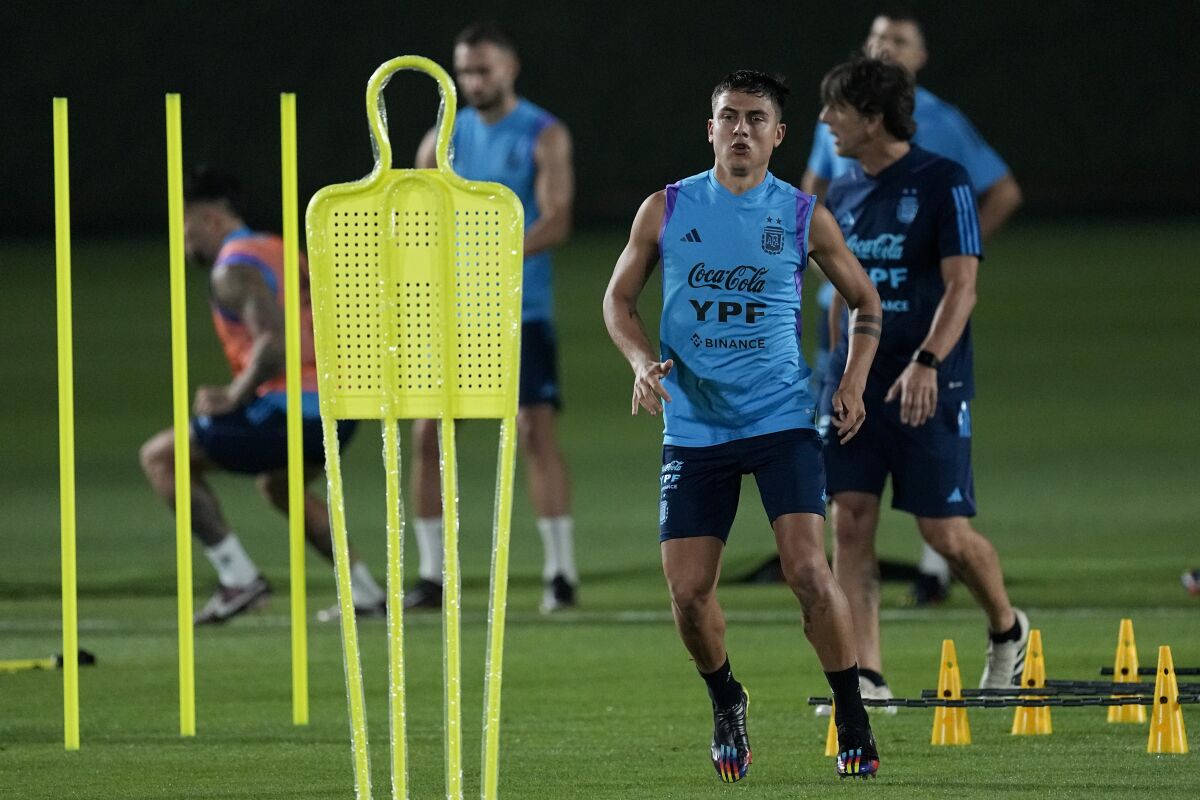 Paulo Dybala runs during a training session of Argentina's national soccer team in Doha, Saturday, Nov. 19, 2022. (AP Photo/Jorge Saenz)
