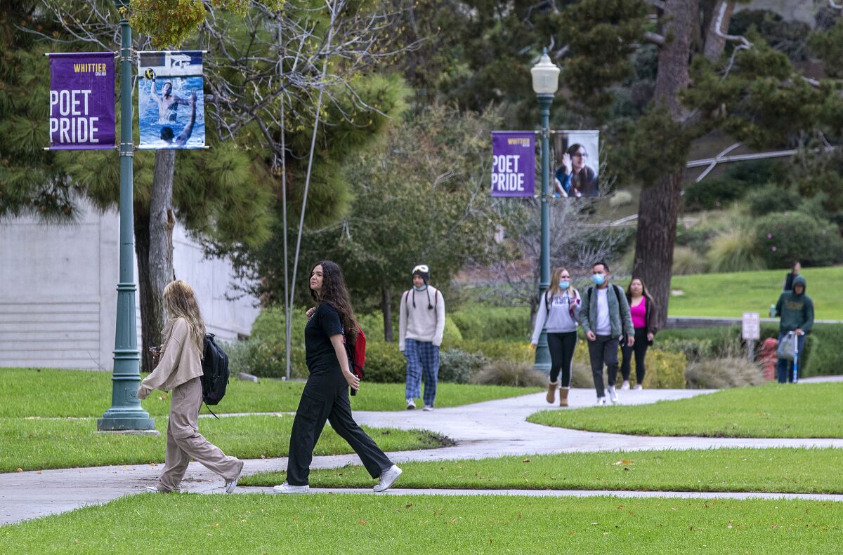 Students walk on a college campus.