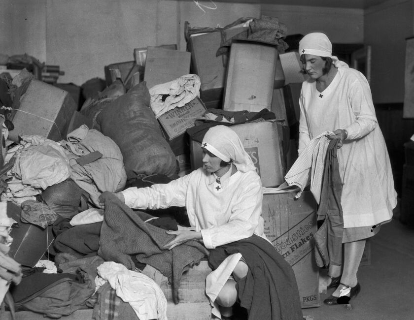 Two Red Cross workers sorted clothing donations 