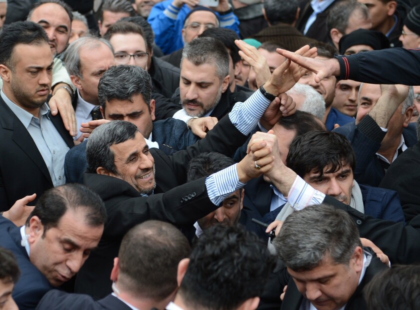 Former Iranian President Mahmoud Ahmadinejad among a crowd of men in Bursa