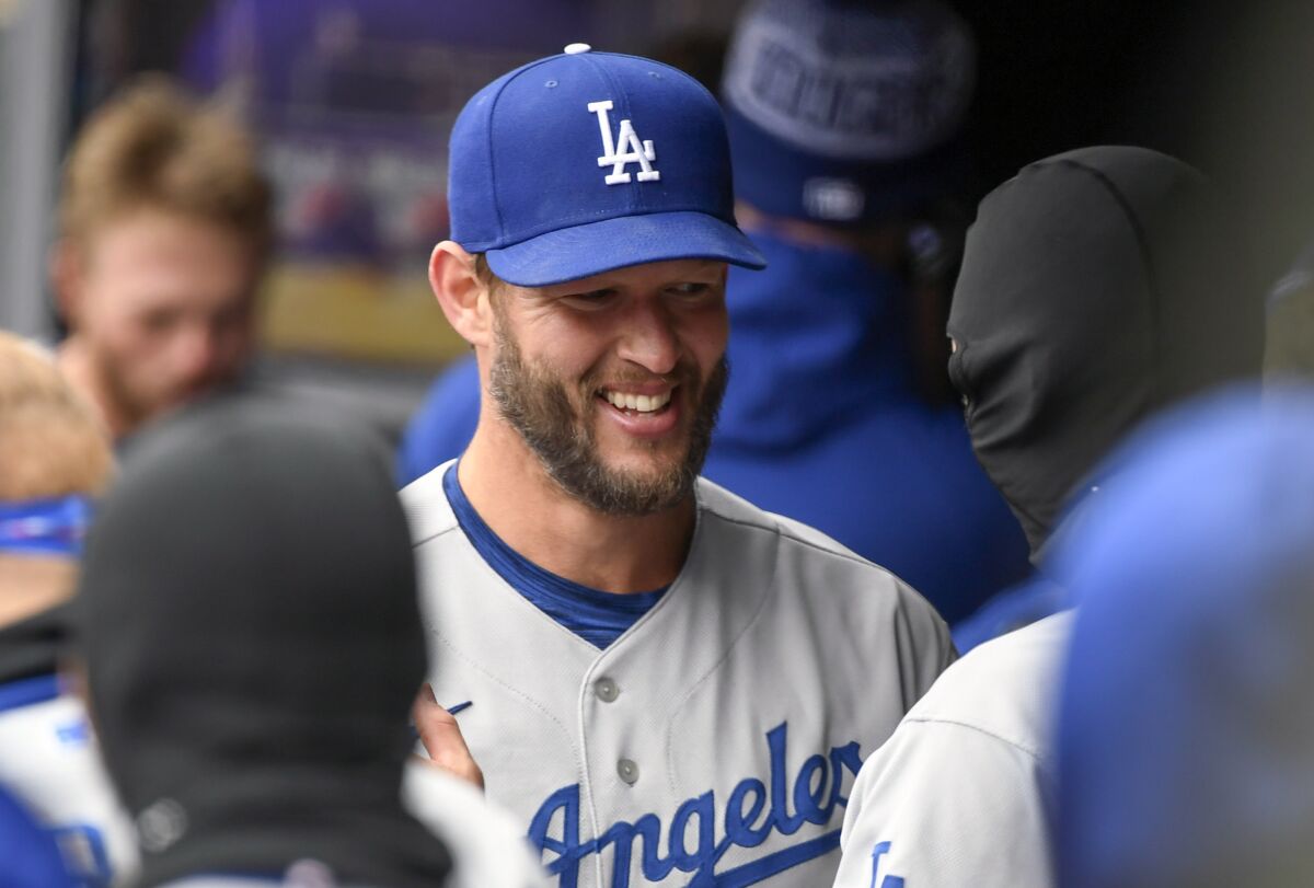 Dodgers pitcher Clayton Kershaw celebrates with teammates pitching seven perfect innings in his season debut.