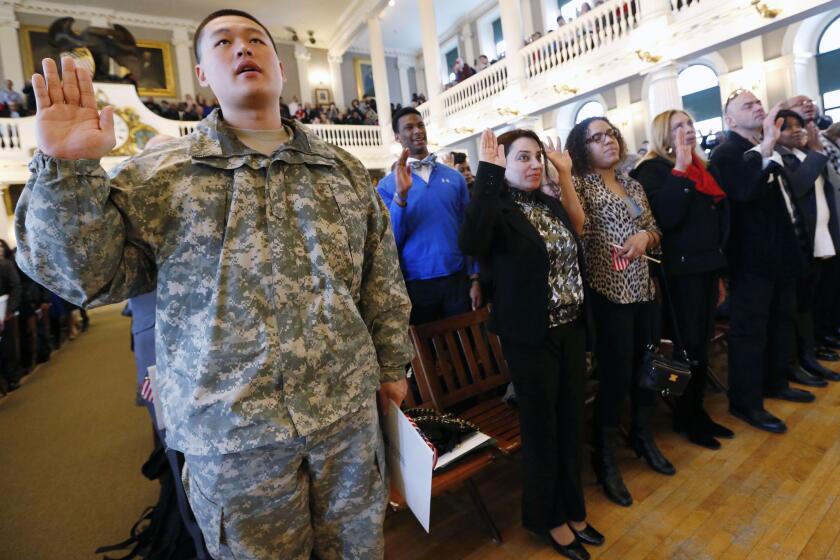 Massachusetts National Guardsmen Dongmin Yang, a South Korean immigant, takes the oath of U.S. citizenship during a naturalization ceremony at Faneuil Hall in Boston last month. The House measure considered Thursday seeks to allow some immigrants in the U.S. illegally to join the military.