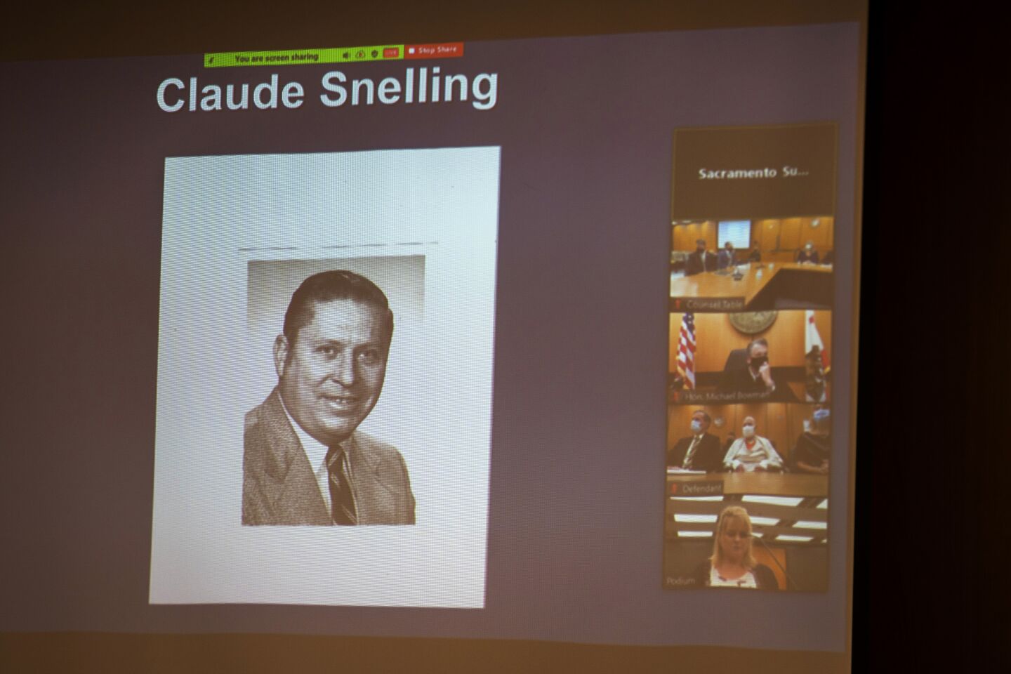 A photo of Claude Snelling is projected onto a screen in a courtroom.