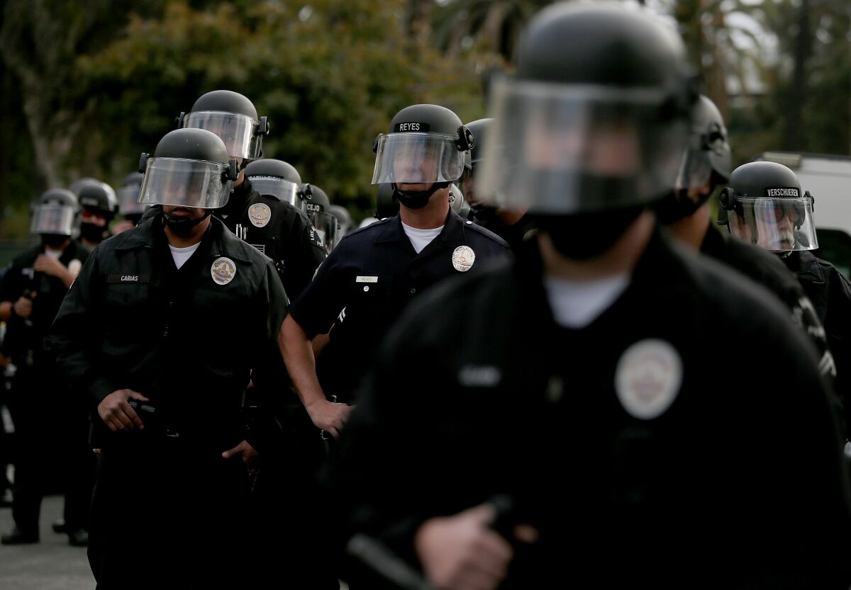 Los Angeles police officers wearing helmets with face shields