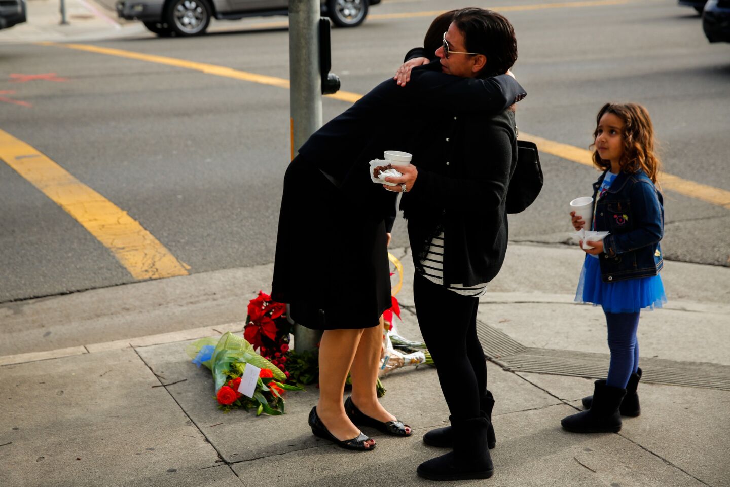 Emotions overflow at a memorial at the corner of Vincent Street and Pacific Coast Highway in Redondo Beach on Thursday morning. Three women died after being struck Wednesday night in a crosswalk in front of St. James Catholic Church.