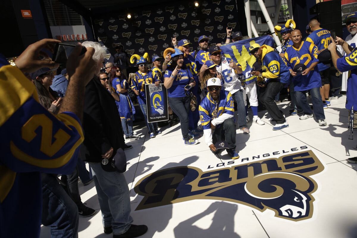 Rams fans pause for photos next to the team's logo at a draft party on April 28, 2016 at L.A. Live.