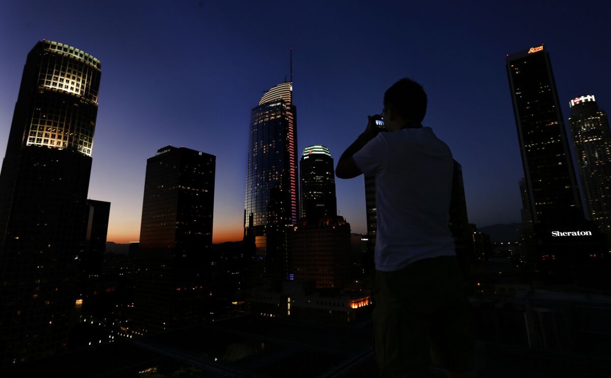 The Wilshire Grand, the third skyscraper from the left, is photographed at dusk. (Mel Melcon / Los Angeles Times)