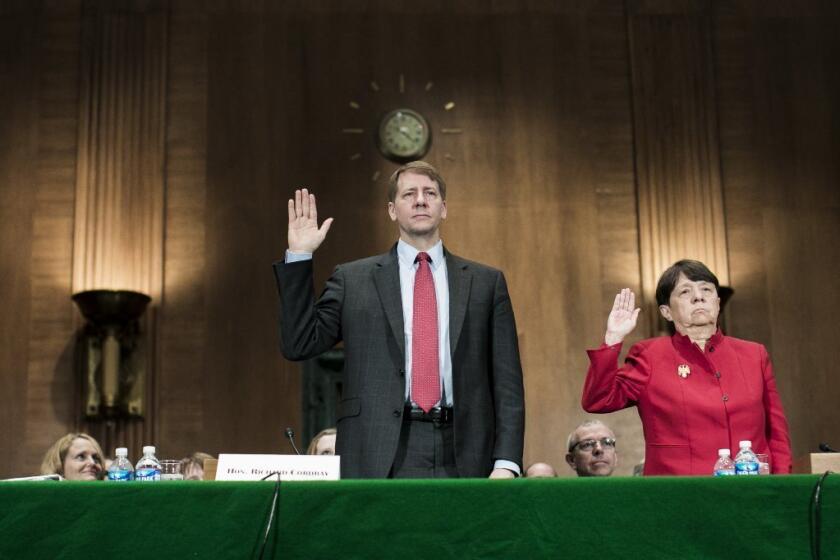 Richard Cordray, nominee for director of the Consumer Financial Protection Bureau, and Mary Jo White, nominee for chair of the Securities and Exchange Commission, are sworn in prior to testifying at a confirmation hearing before the Senate Committee on Banking, Housing and Urban Affairs last week.