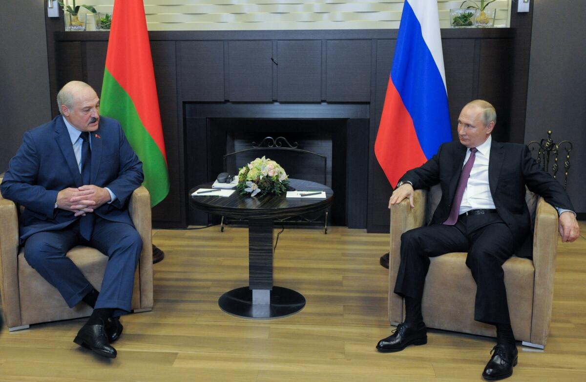 Russian President Vladimir Putin, right, and Belarusian President Alexander Lukashenko talk.