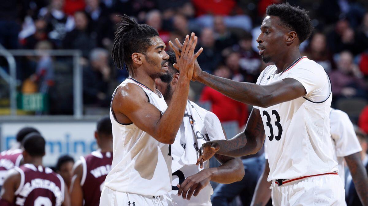 Cincinnati's Jacob Evans (1) and Nysier Brooks (33) celebrate in the second half against Mississippi State on Tuesday.