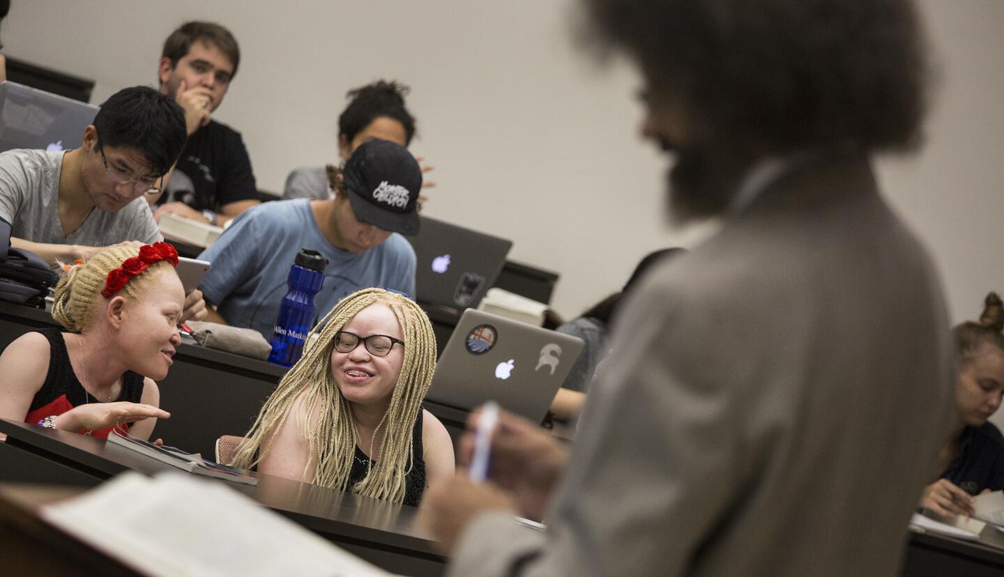 Tindi, left, and Bibiana Mashamba, albino sisters from Tanzania, sit in on professor Jody Armour's USC tort law class on Aug. 24. They just received asylum in the U.S.