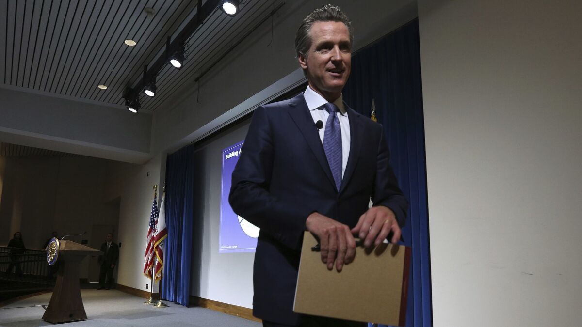 Gov. Gavin Newsom leaves the stage after presenting his first state budget proposal during a news conference Thursday in Sacramento.