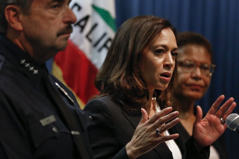 California Attorney General Kamala Harris alongside LAPD Chief Charlie Beck (left) and Rep. Karen Bass (right) during a press conference at the Ronald Reagan Building in Los Angeles on September 2.