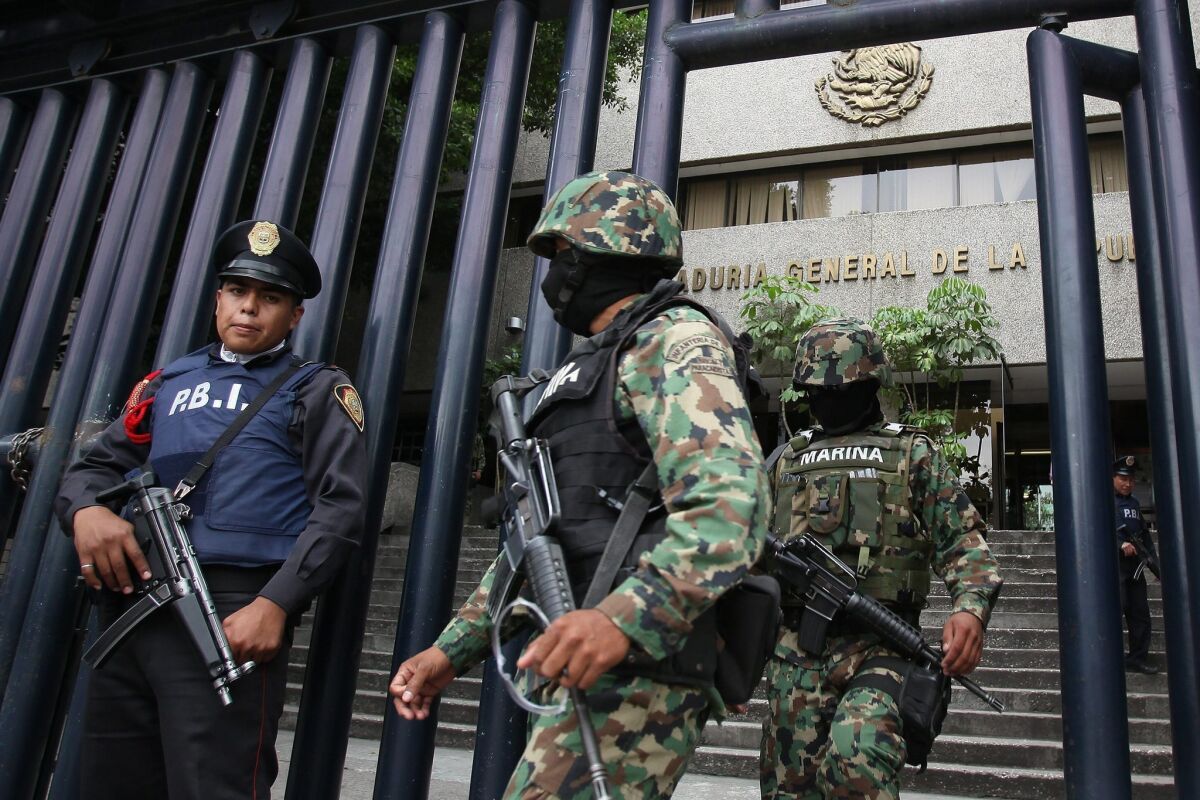 Mexican soldiers guard the building where Miguel Angel Treviño Morales, alias Z-40, is being held. The Mexican government arrested Morales in their fight against drug trafficking.