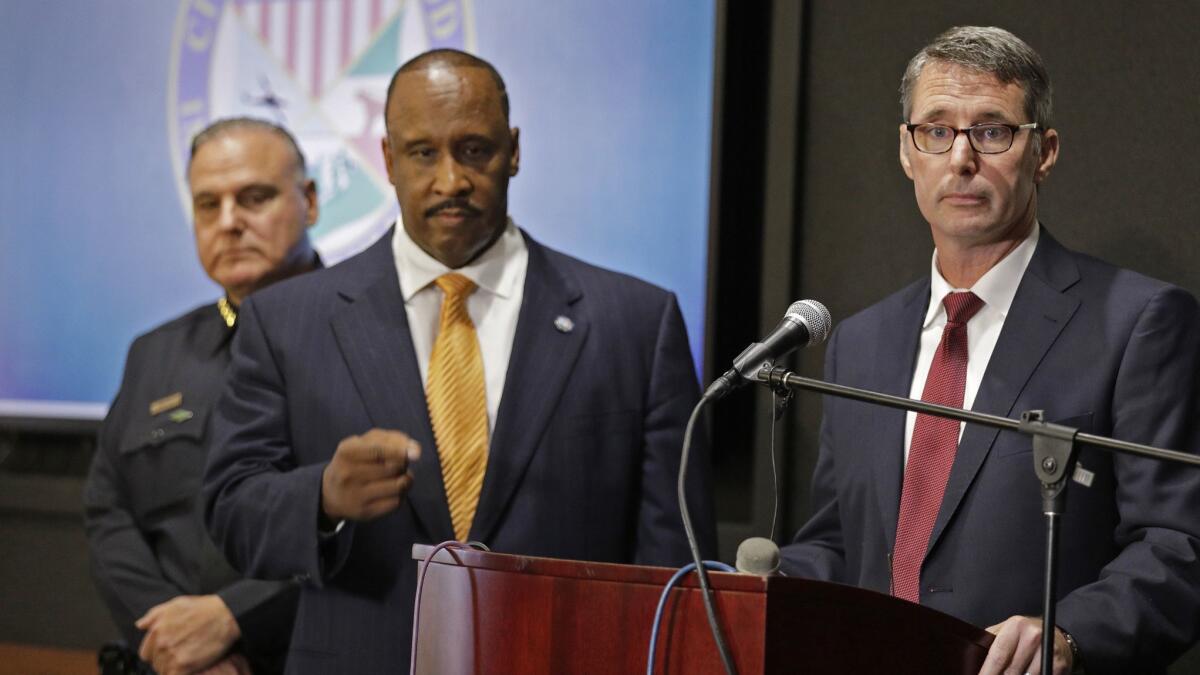 Paul Delacourt, right, assistant director in charge of the FBI's Los Angeles office, takes questions after announcing the arrest of 10 Osage Legend Crips members. He is joined by Inglewood Police Chief Mark Fronterotta, left, and Mayor James T. Butts.