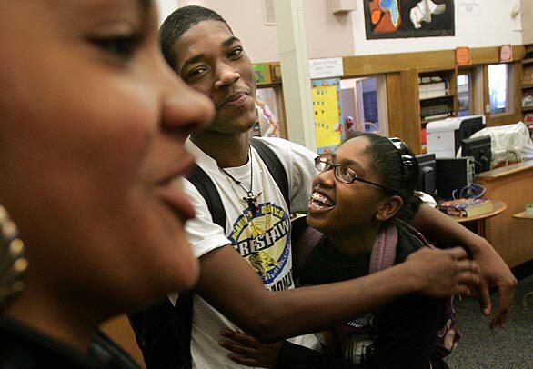 Hyacinth Noble, left, and Brandi Thibodeaux, right, surround Pierre Dupree after learning that he had voted in Tuesday's election. They were at a monthly meeting of student leaders at Crenshaw HIgh School and were discussing Barack Obama's historic victory in the presidential race. "You didn't even tell us you had voted and you didn't wear your sticker," they teased Dupree, who replied that he was saving his "I Voted" sticker at home.