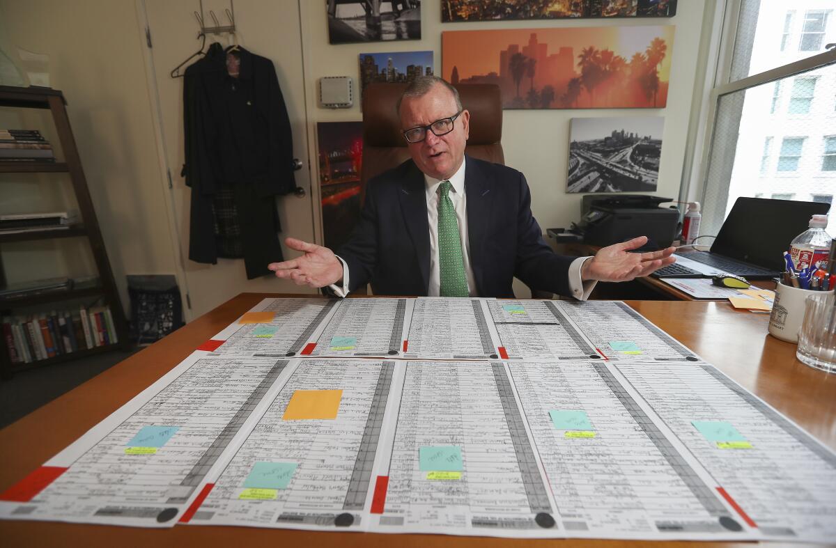 Hal Bastian with copies of the signed petitions submitted by his campaign