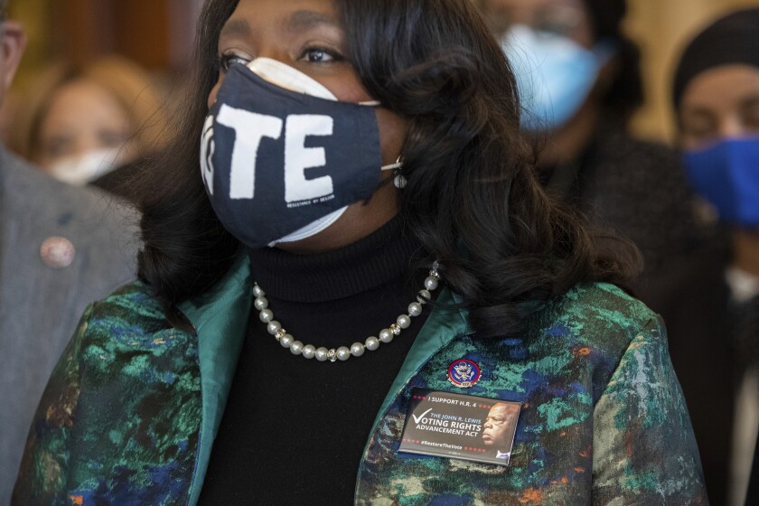 Rep. Terri Sewell, D-Ala., wears a pin honoring John Lewis while standing alongside other members of the Congressional Black Caucus speaking in front of the Senate chambers about their support of voting rights legislation at the Capitol in Washington, Wednesday, Jan. 19, 2022. (AP Photo/Amanda Andrade-Rhoades)