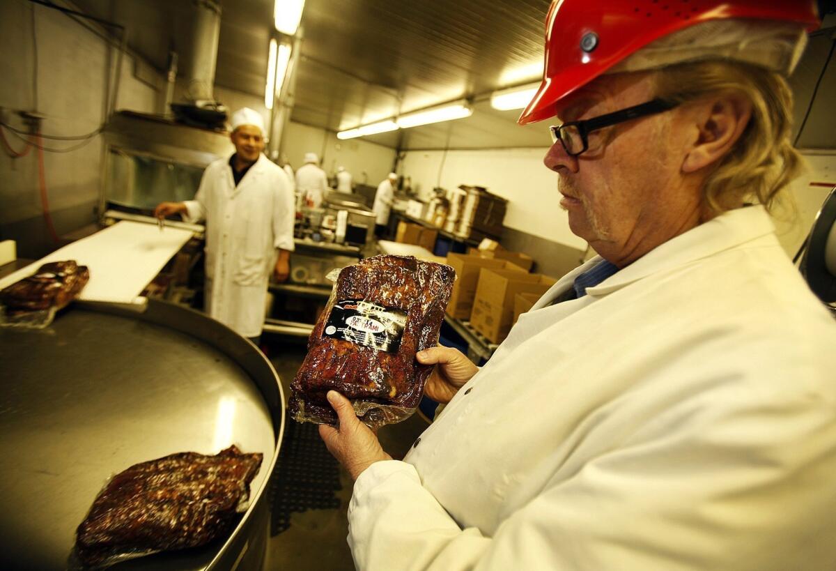 Food prices increased in March, the U.S. Bureau of Labor Statistics reported Tuesday. Above, Jerry Haines, general manager of R.C. Provision in Burbank, holds pastrami that's ready for shipping. The company, which supplies Pink's, Langer's Delicatessen and other eateries, is struggling as beef prices have hit a record high in the U.S.