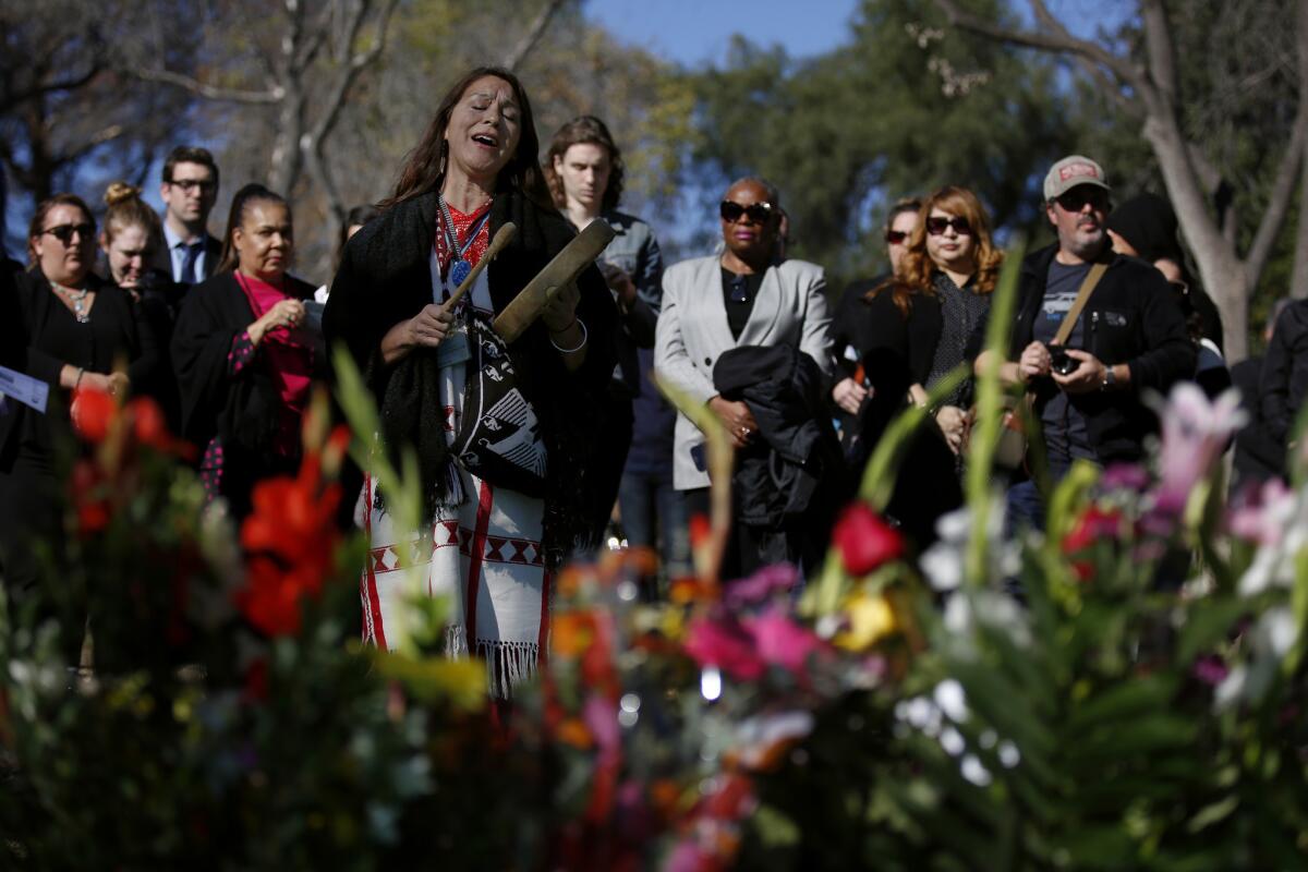 Raquel Salinas takes part in the ceremony at the site of a mass grave in the Los Angeles County Crematory and Cemetery on Wednesday.