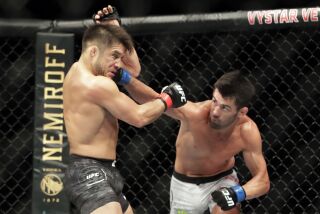 Dominick Cruz, right, punches Henry Cejudo during a UFC 249 mixed martial arts bout, Saturday, May 9, 2020, in Jacksonville, Fla. (AP Photo/John Raoux)