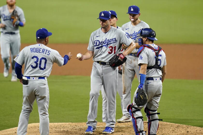 Dodgers starting pitcher Max Scherzer hands the ball to manager Dave Roberts (30)
