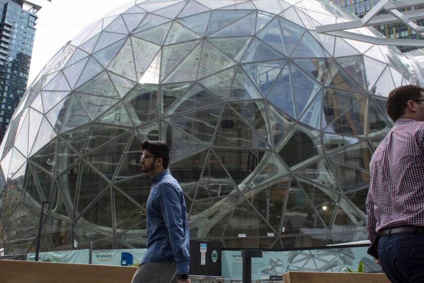 SEATTLE, WA - JUNE 16: People walk past the signature glass spheres under construction at the Amazon corporate headquarters on June 16, 2017 in Seattle, Washington. Amazon announced that it will buy Whole Foods Market, Inc. for over $13 billion. (Photo by David Ryder/Getty Images) ** OUTS - ELSENT, FPG, CM - OUTS * NM, PH, VA if sourced by CT, LA or MoD **