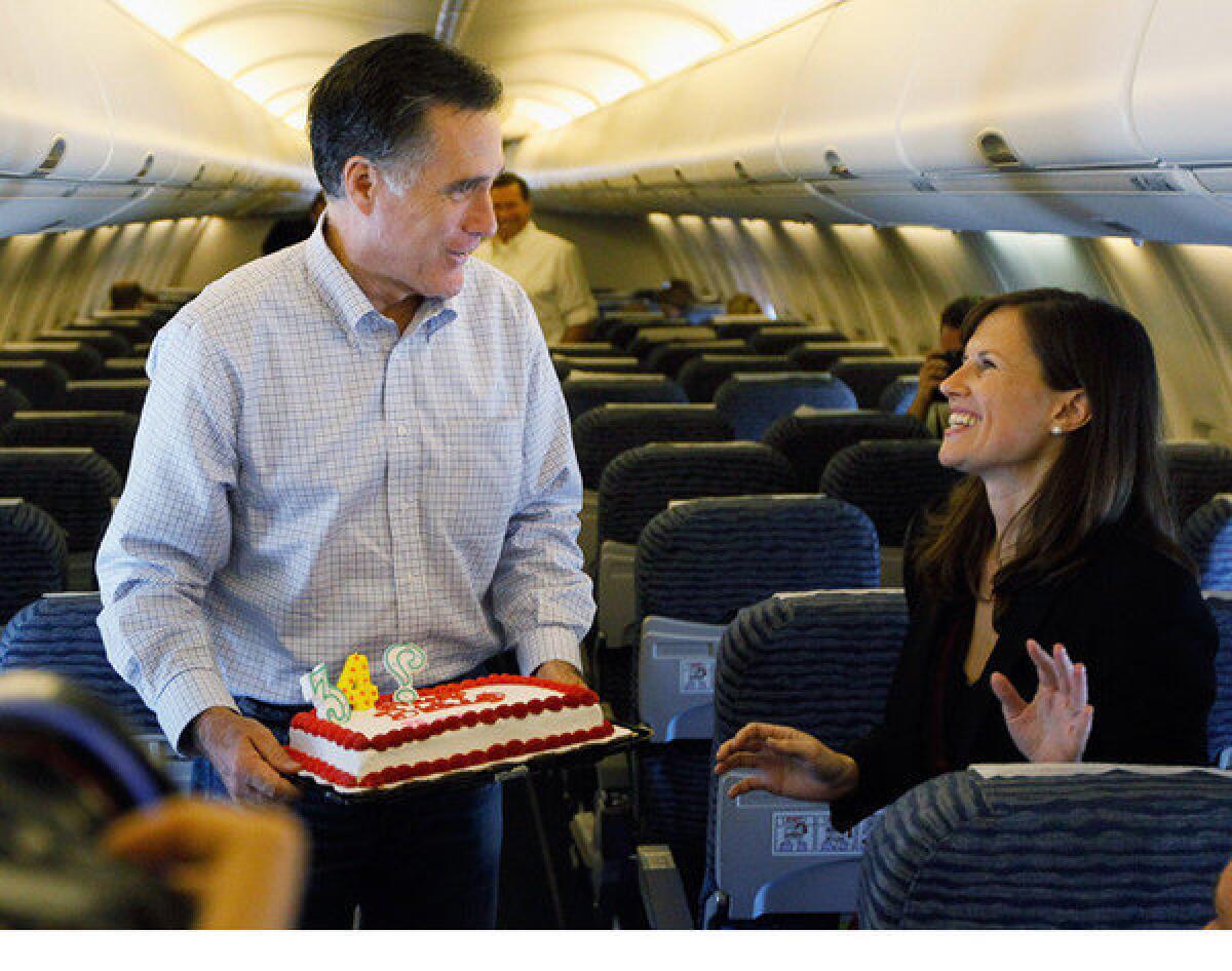 Mitt Romney brings Times reporter Maeve Reston a birthday cake earlier this year on his campaign plane during a stop in Jacksonville, Fla.