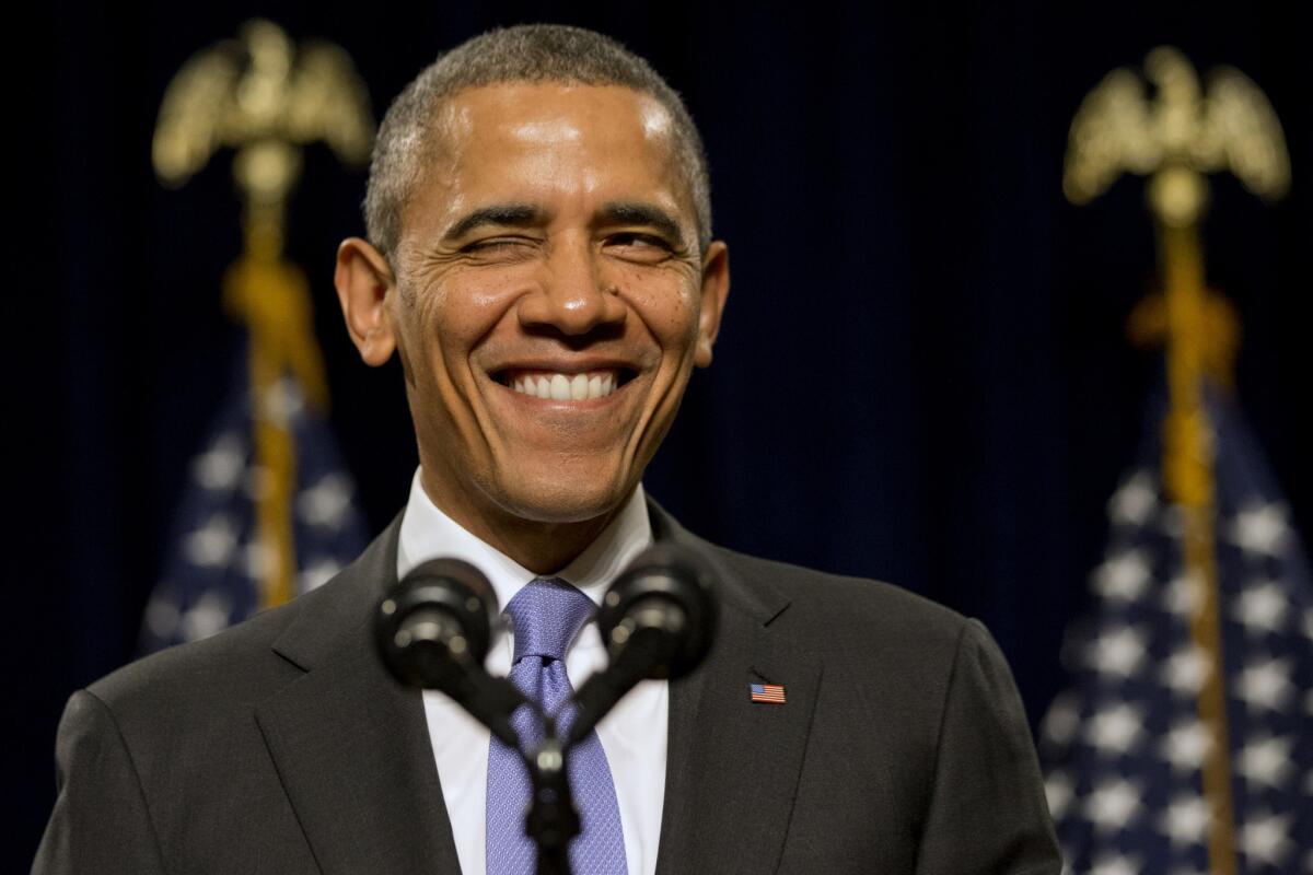 President Obama winks as he is welcomed before speaking to the House Democratic Issues Conference in Cambridge, Md. Obama said top priorities for Congress should be increasing the minimum wage and reforming immigration.