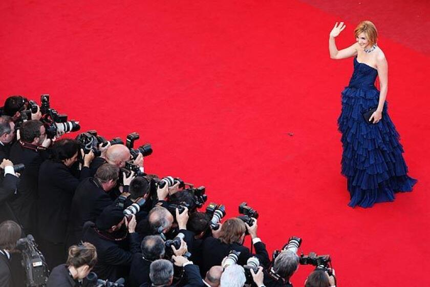 Actress Clotilde Courau waves for the cameras at the Cannes Film Festival in Cannes, France.