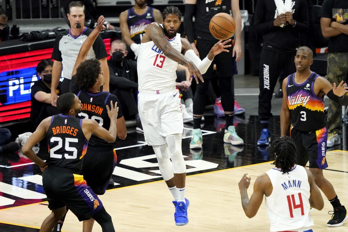 Clippers forward Paul George passes after driving to the basket against the Suns during Game 5.