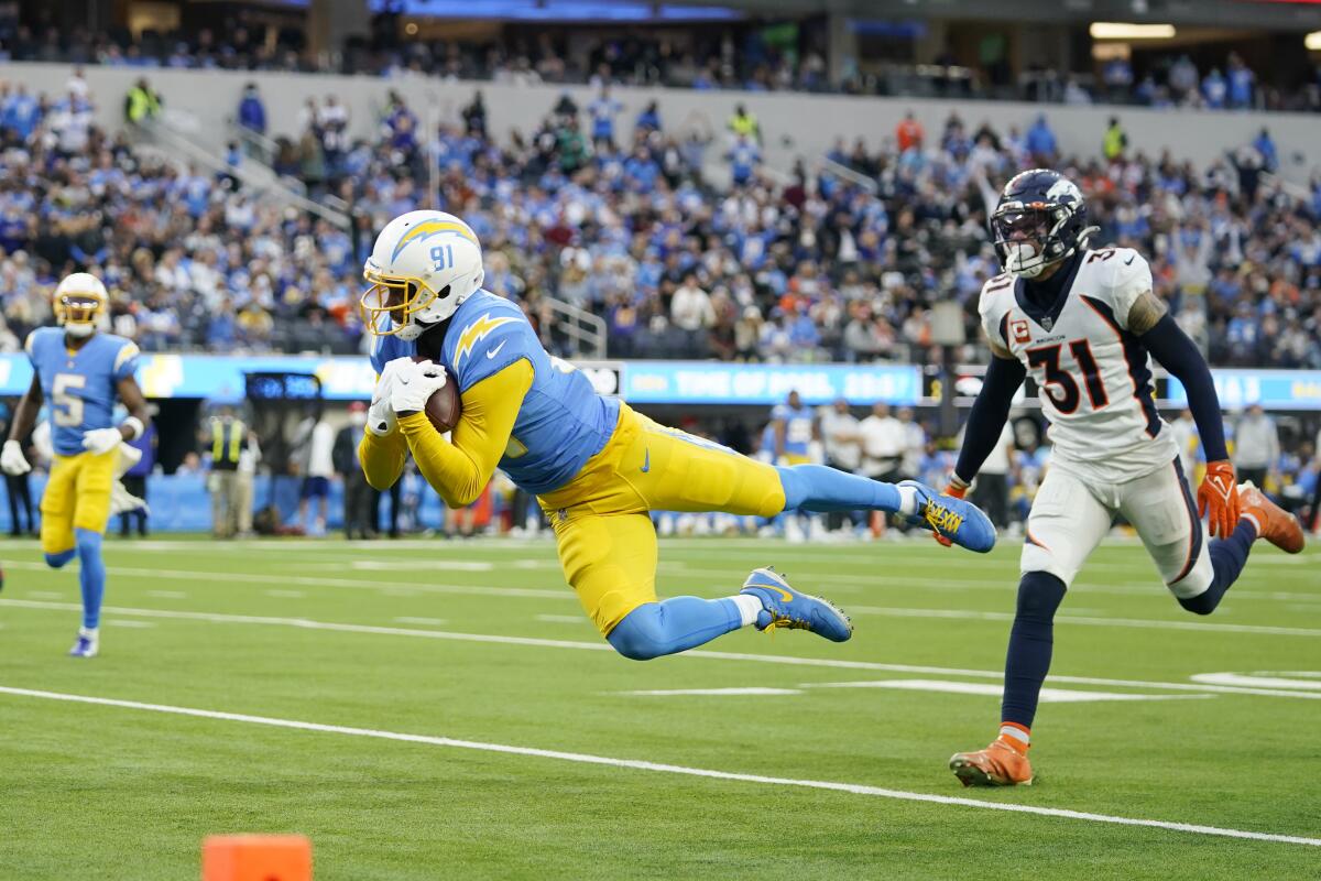 Chargers wide receiver Mike Williams catches a touchdown pass in front of Denver Broncos free safety Justin Simmons.