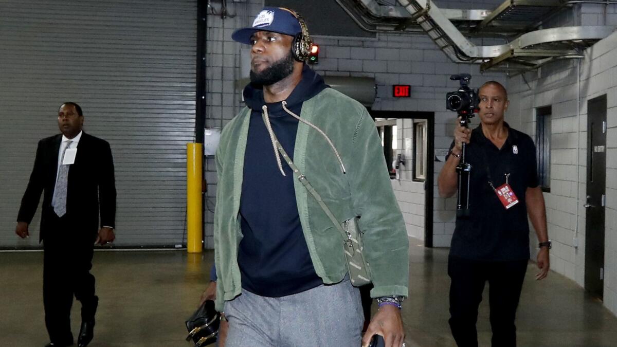 Lakers star LeBron James arrives for the season opening game against the Trail Blazers.
