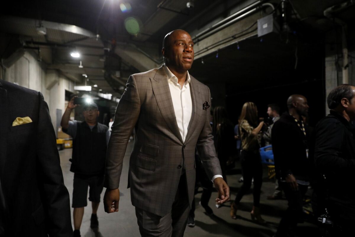 Magic Johnson walks down a corridor at Staples Center after announcing his resignation as the Lakers’ president of basketball operations in April.